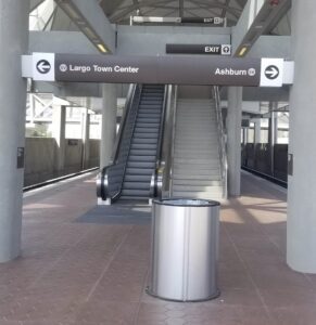 an escalator and a sign in a station