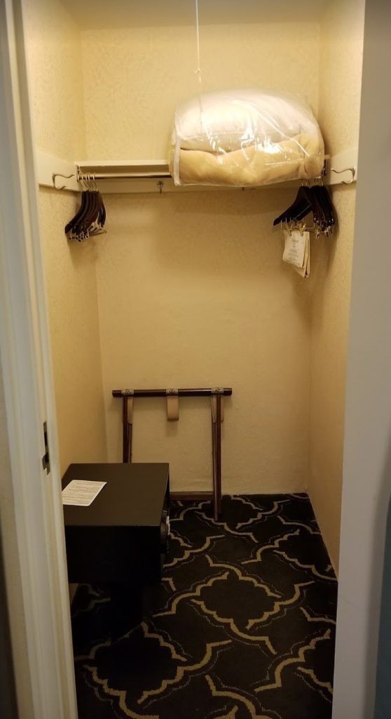 a closet with swingers and a table