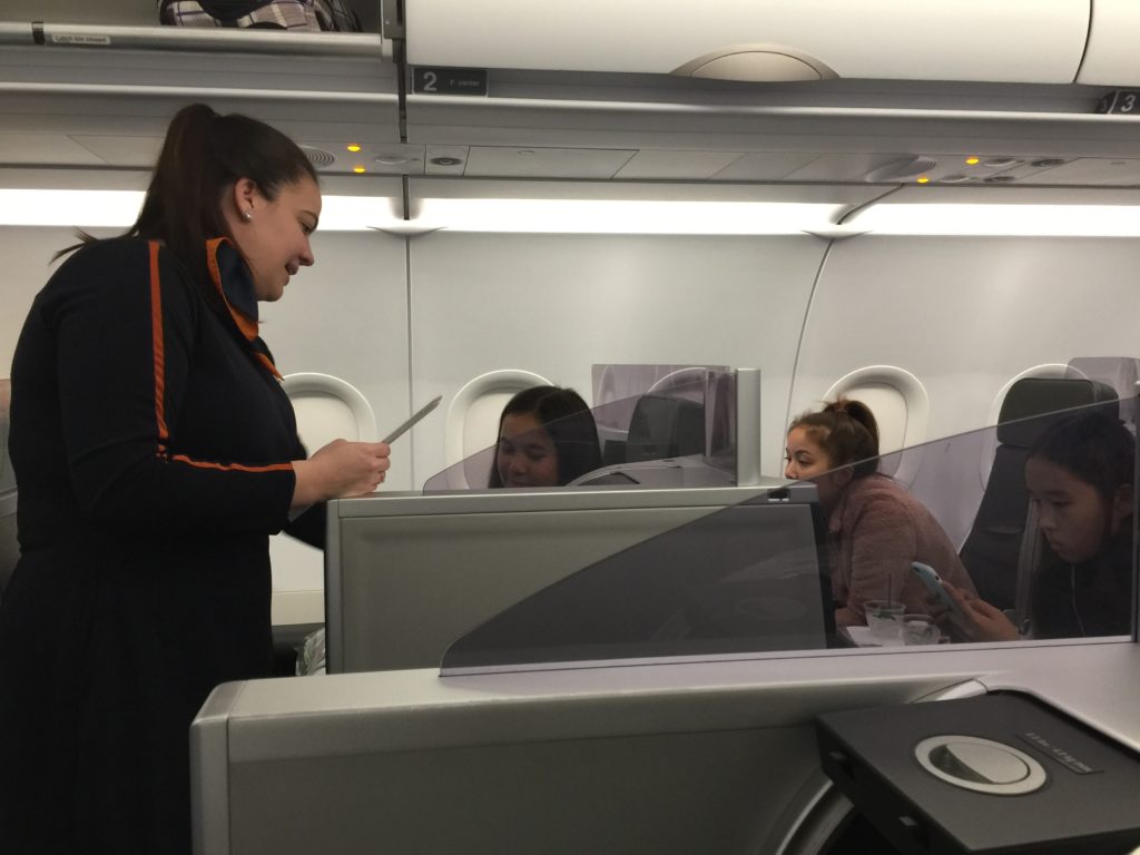 a woman standing in an airplane