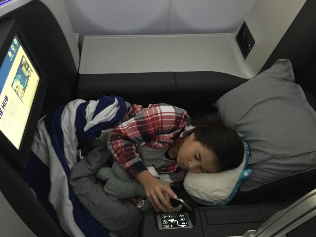 a woman sleeping on a plane