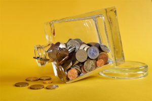 a glass jar filled with coins