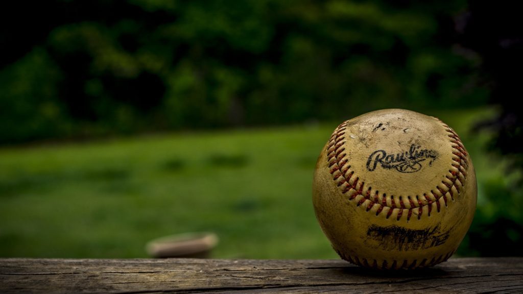 a baseball on a wood surface