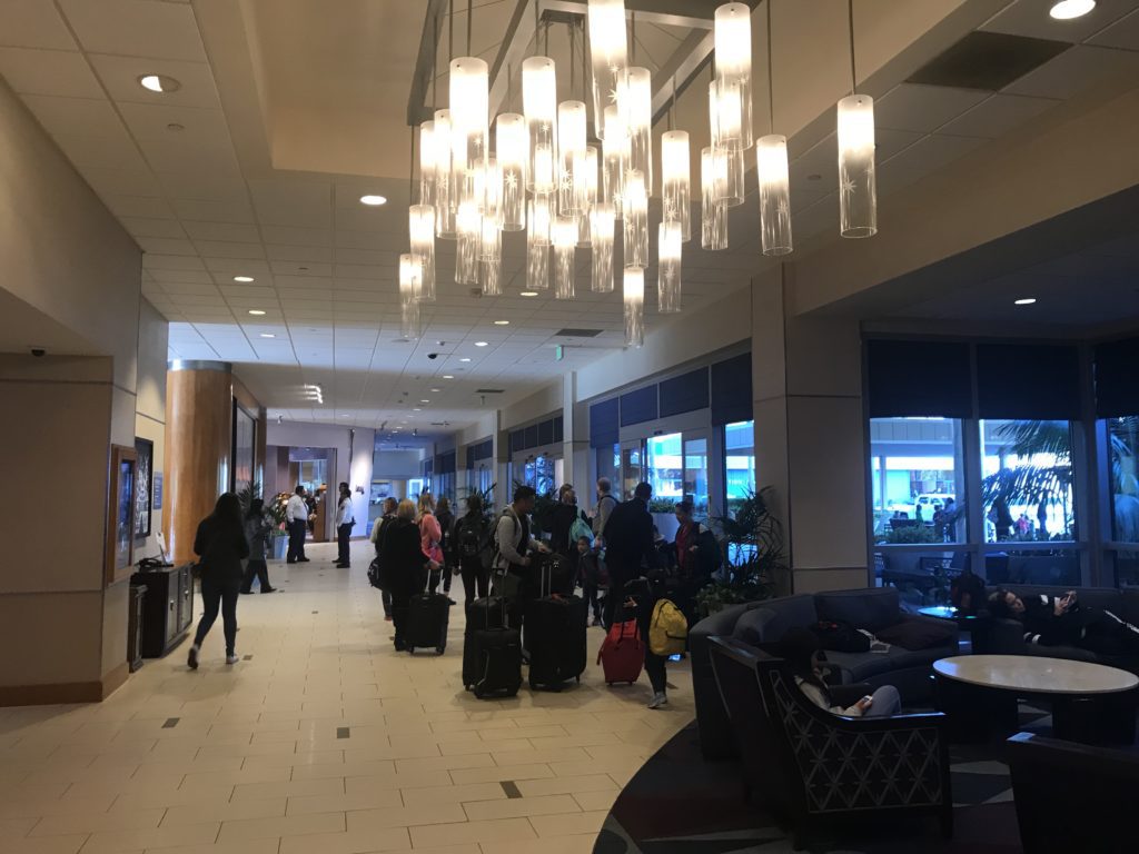a group of people with luggage in a lobby