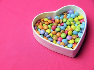 a heart shaped box filled with candy