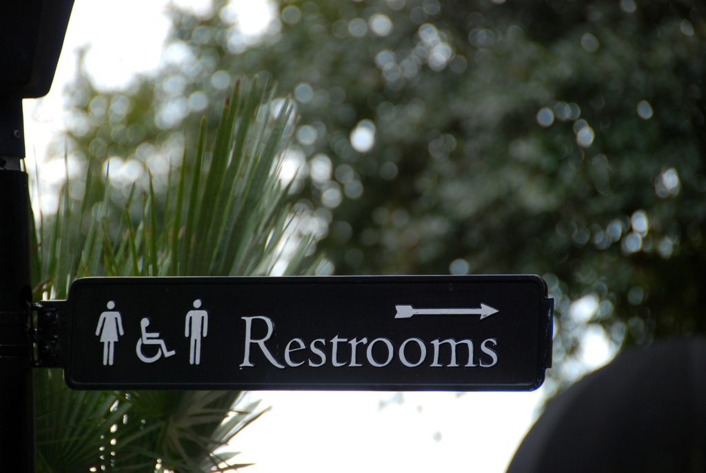 a sign with a person and a man and woman on it
