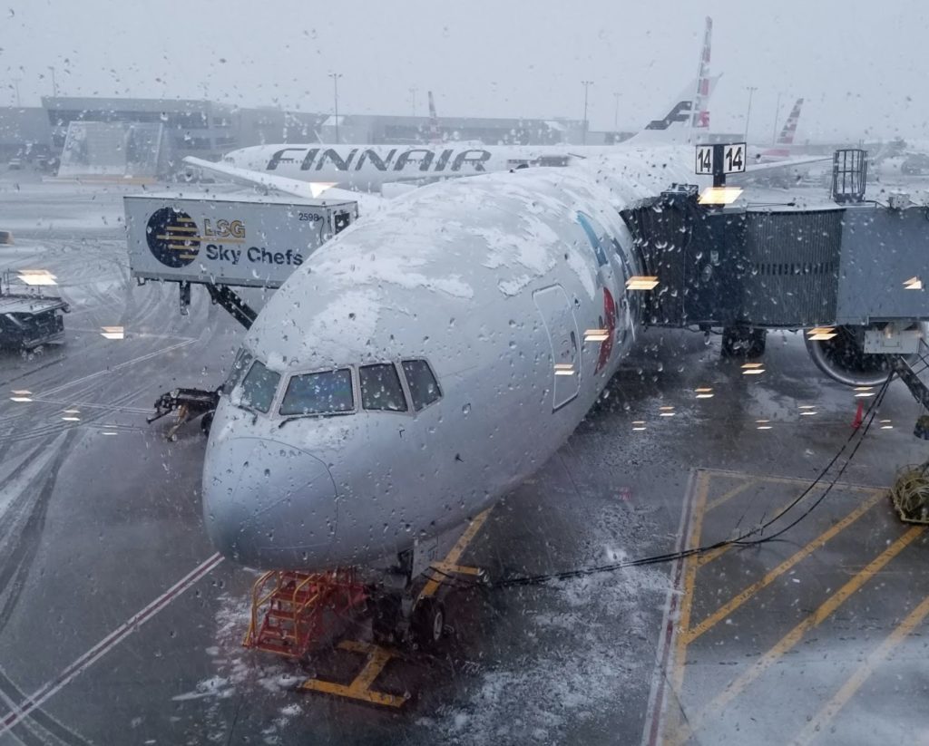 an airplane on a runway in the snow