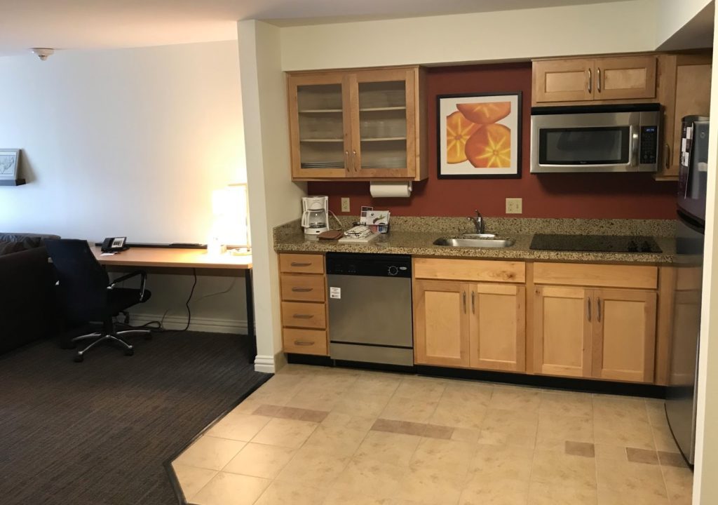 a kitchen with a desk and a microwave