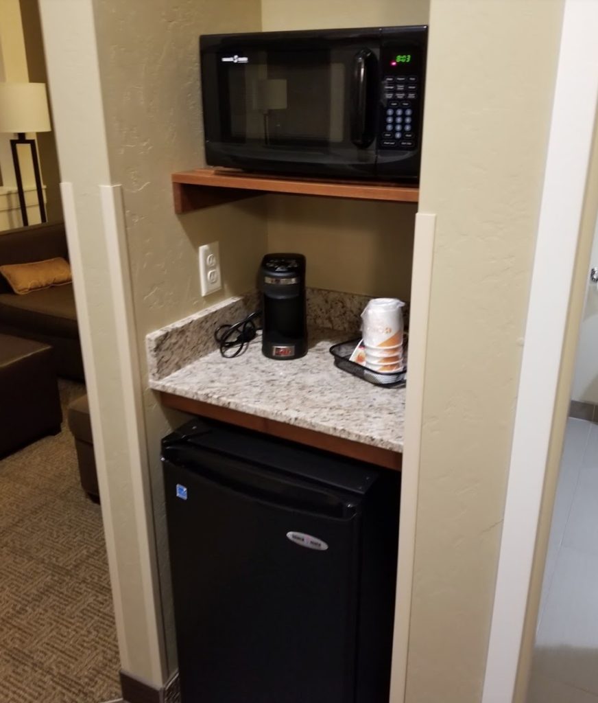 a microwave and mini fridge in a small kitchen