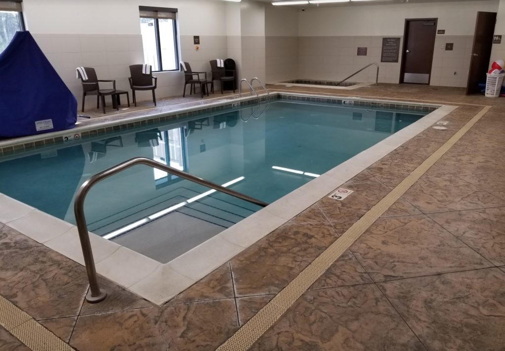 a swimming pool with a metal railing