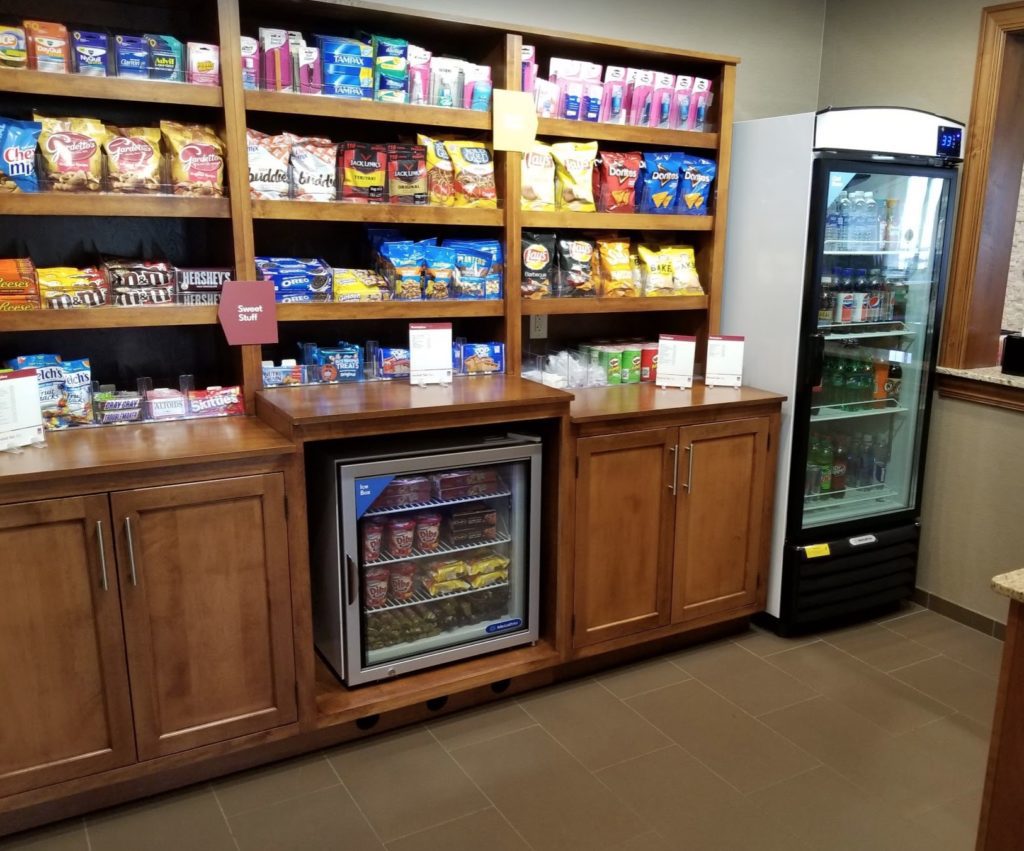 a store with shelves of snacks and a refrigerator