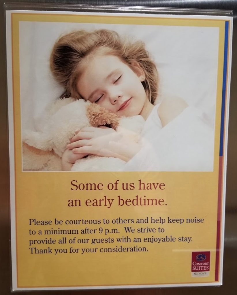 a poster of a girl sleeping with a teddy bear