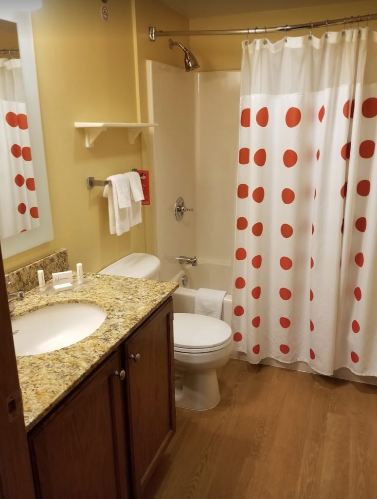 a bathroom with a sink toilet and shower curtain