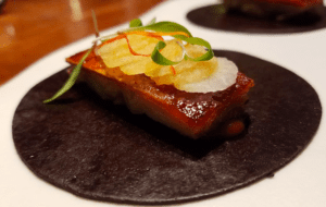 a piece of food on a black plate