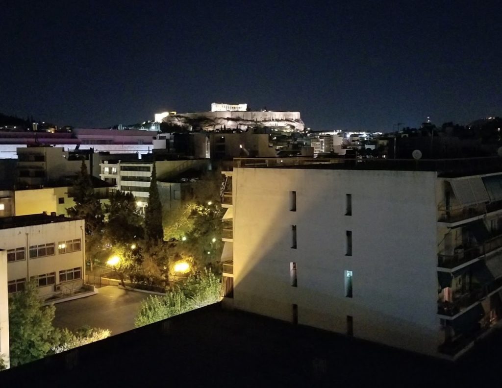 a city at night with a building in the background