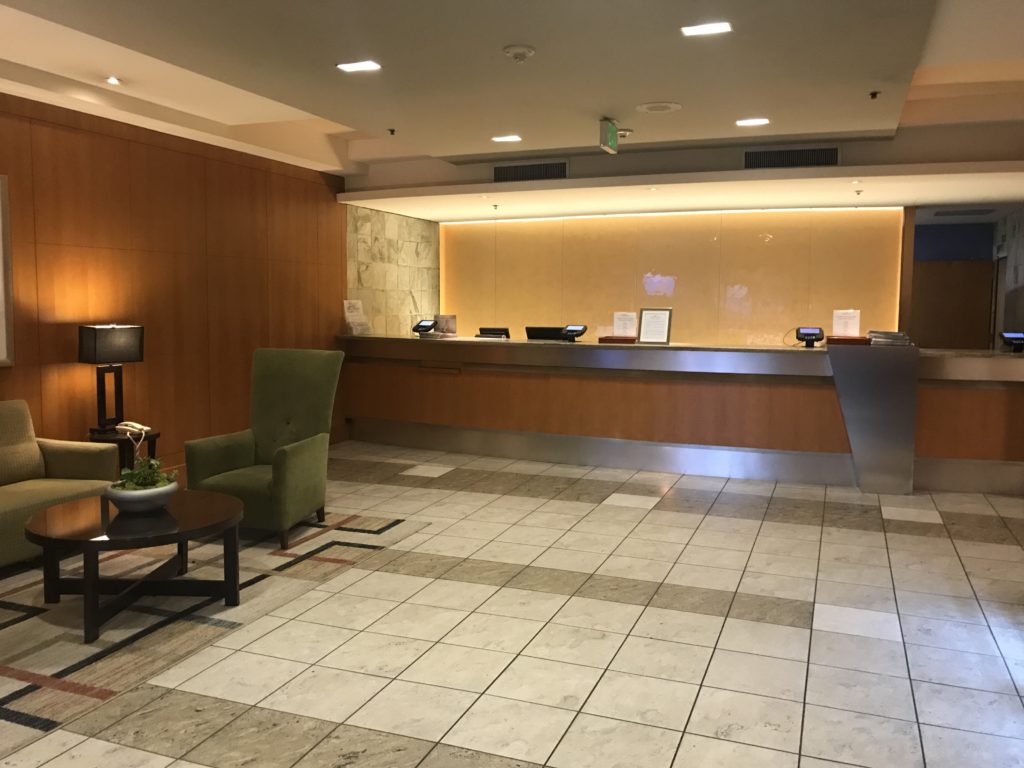 a lobby with a chair and a table