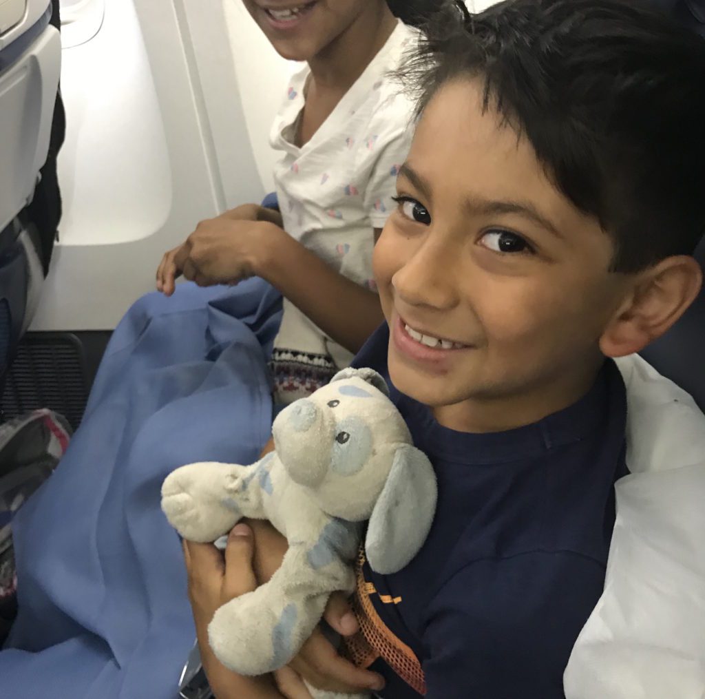 a boy holding a stuffed animal