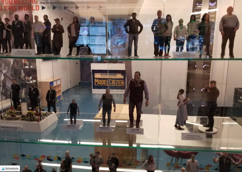 a group of people standing on a glass shelf