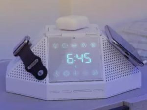 a white electronic clock with a watch and a watch on it