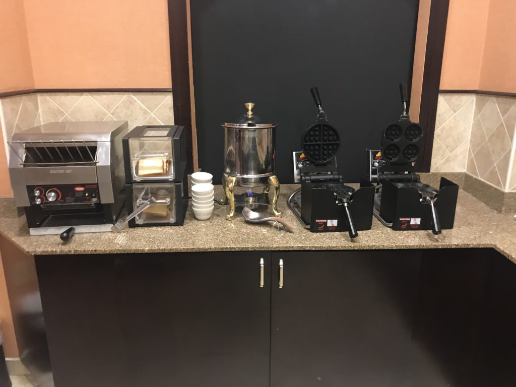 a counter with a machine and waffle maker