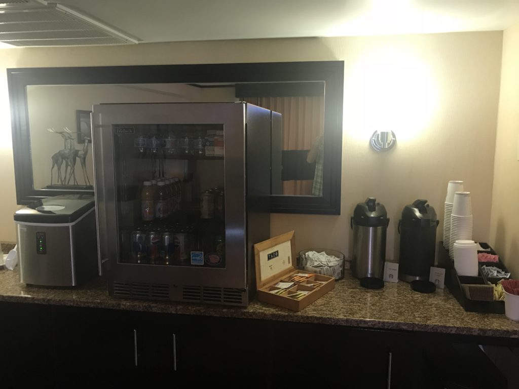 a refrigerator and coffee maker on a counter