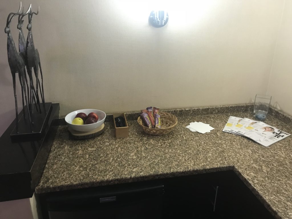 a bowl of fruit and a bowl of candy on a counter