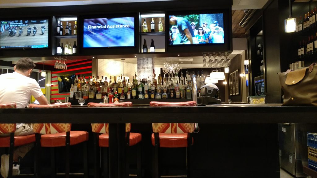 a bar with a television and a tv above it