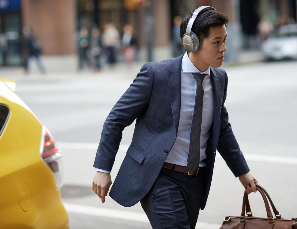 a man wearing headphones and walking on the street