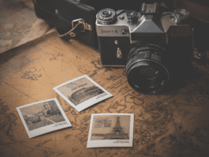 a camera and polaroid pictures on a map
