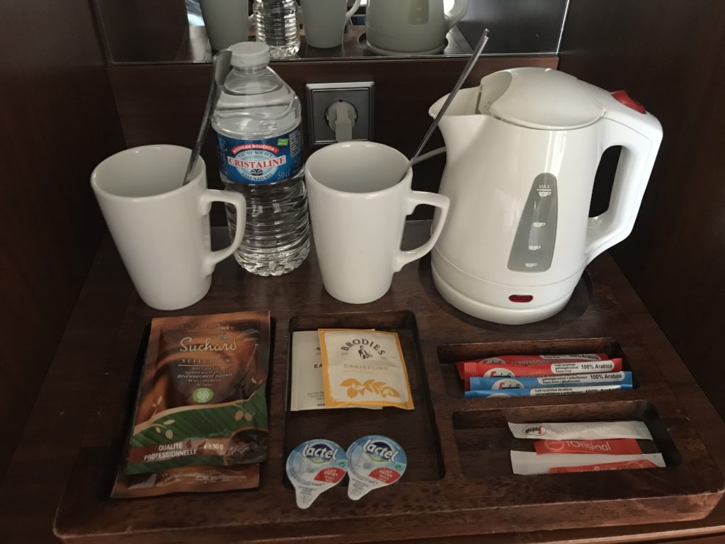 a coffee maker and teapot on a tray