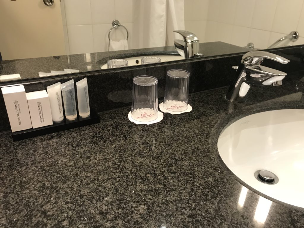 a bathroom sink with a mirror and a couple of glasses