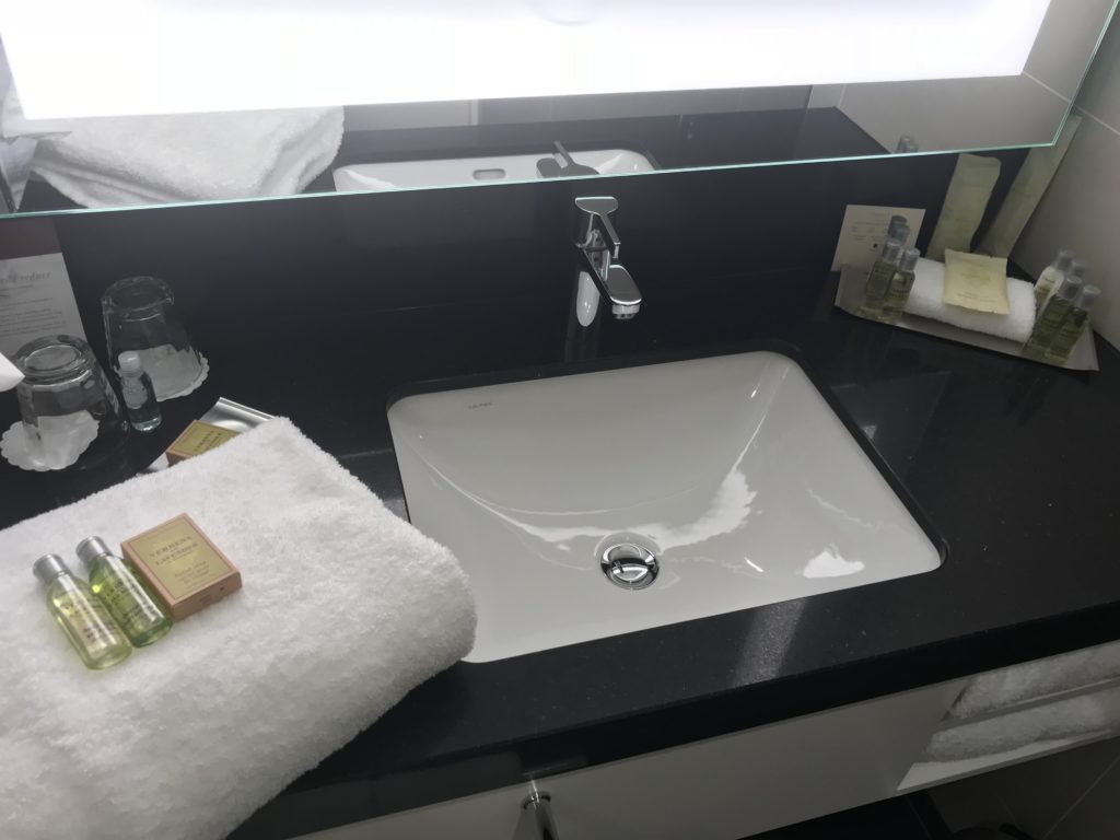 a bathroom sink with a towel and a mirror