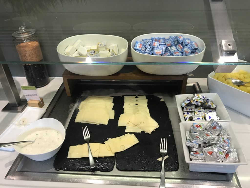a buffet with different types of cheese and other food