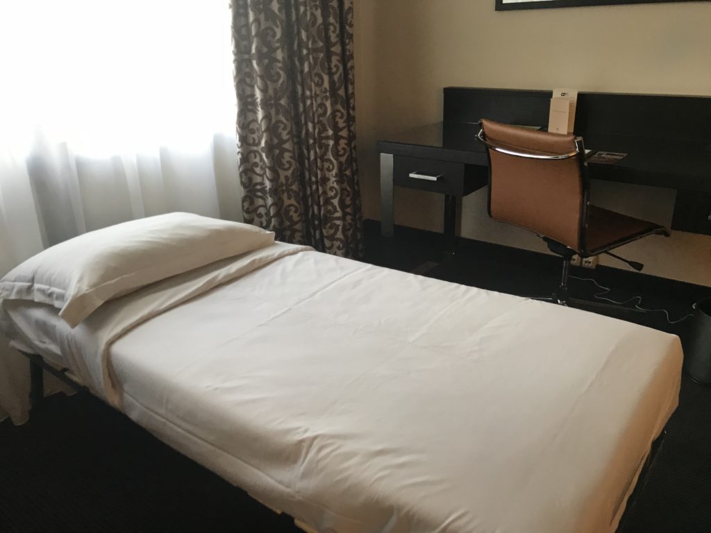 a bed and desk in a room