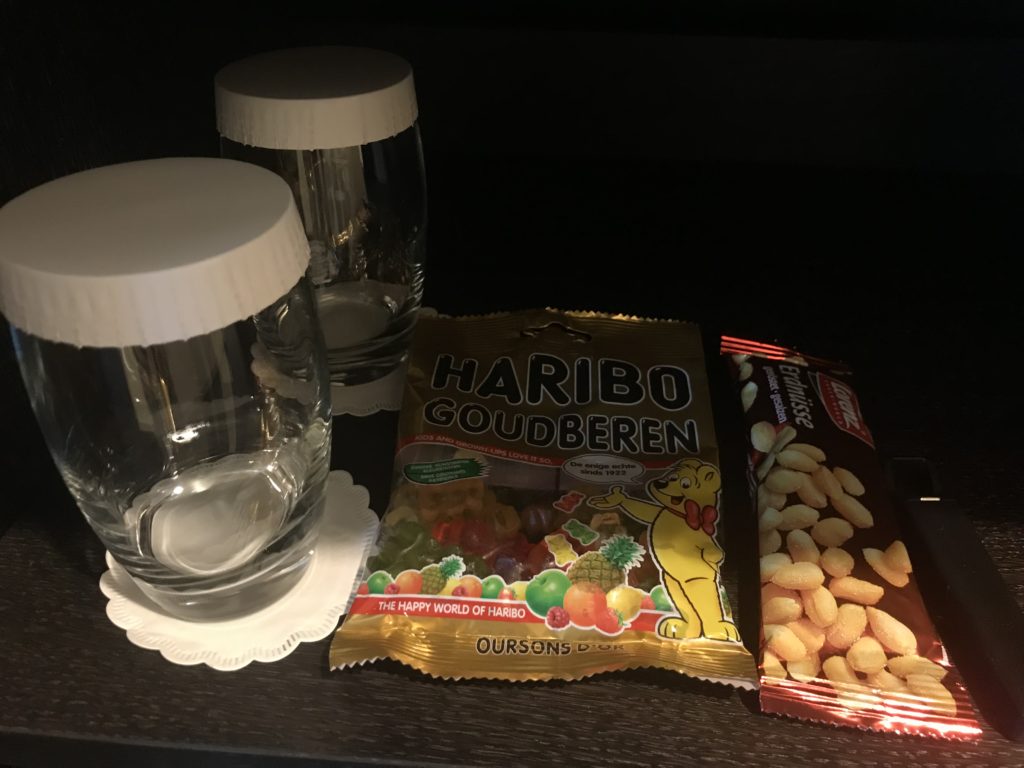 a glass and candy bags on a table