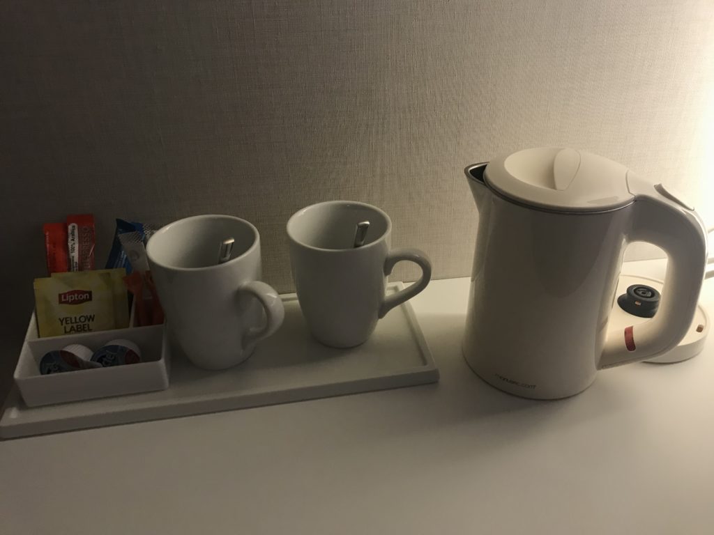a coffee pot and cups on a tray