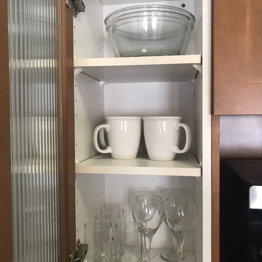 a shelf with cups and glasses