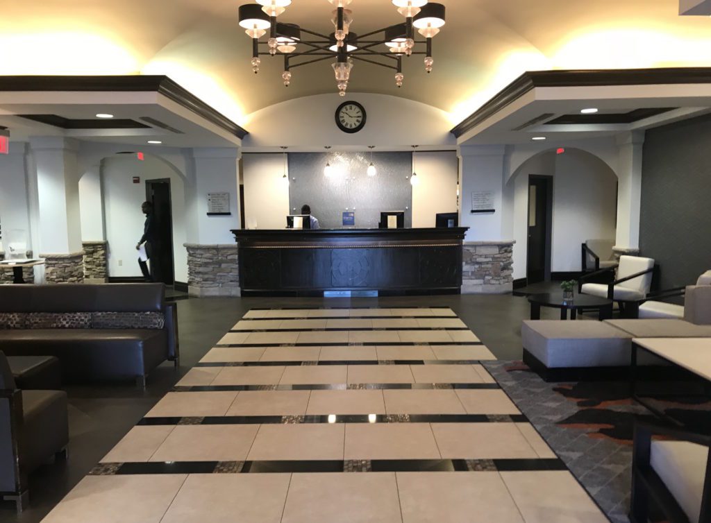 a lobby with a reception desk and a clock