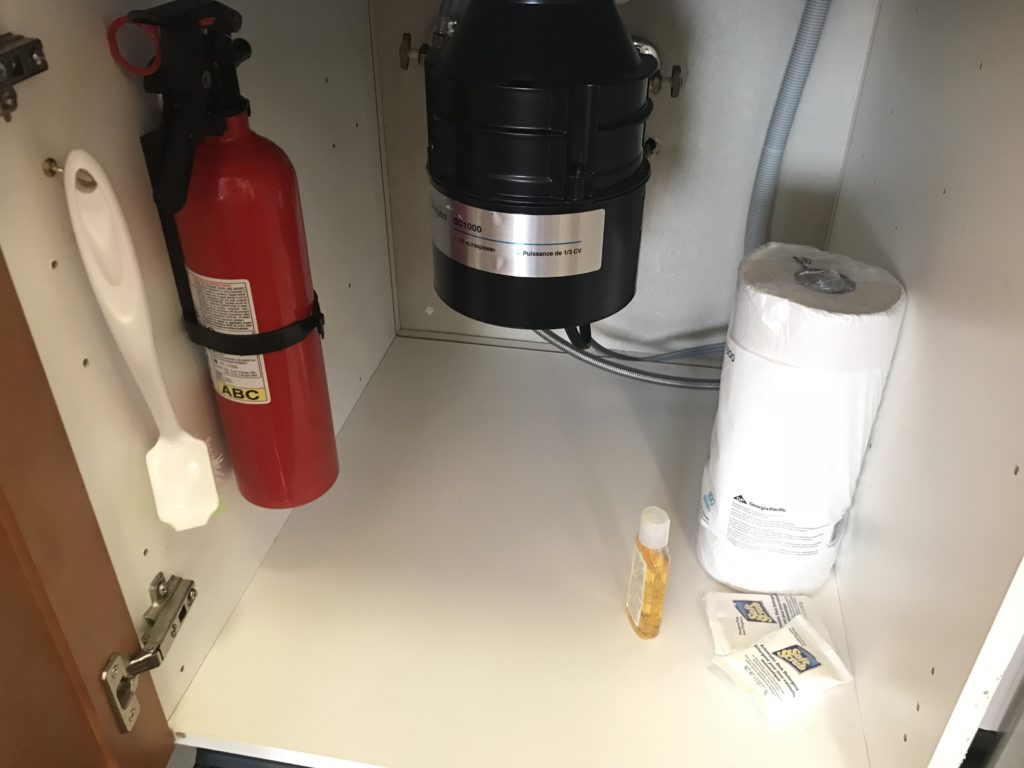 a fire extinguisher and a red fire extinguisher in a cabinet