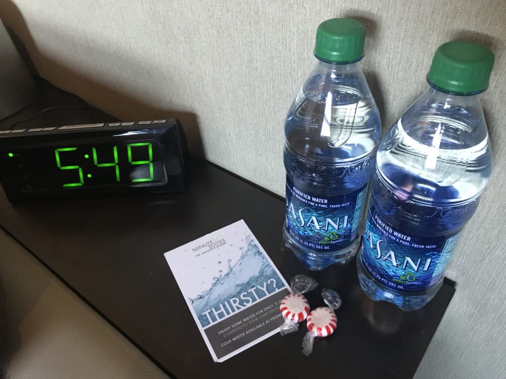 two water bottles next to a clock