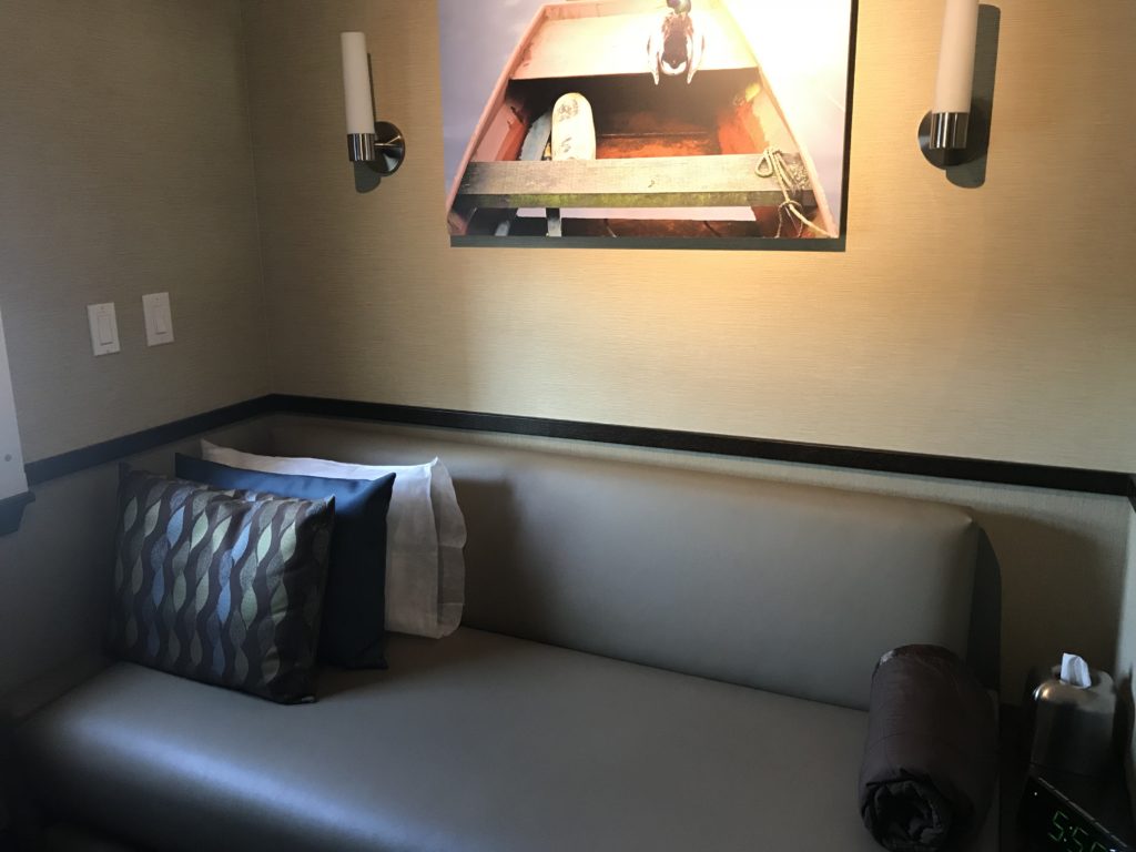 a couch with pillows and a picture on the wall