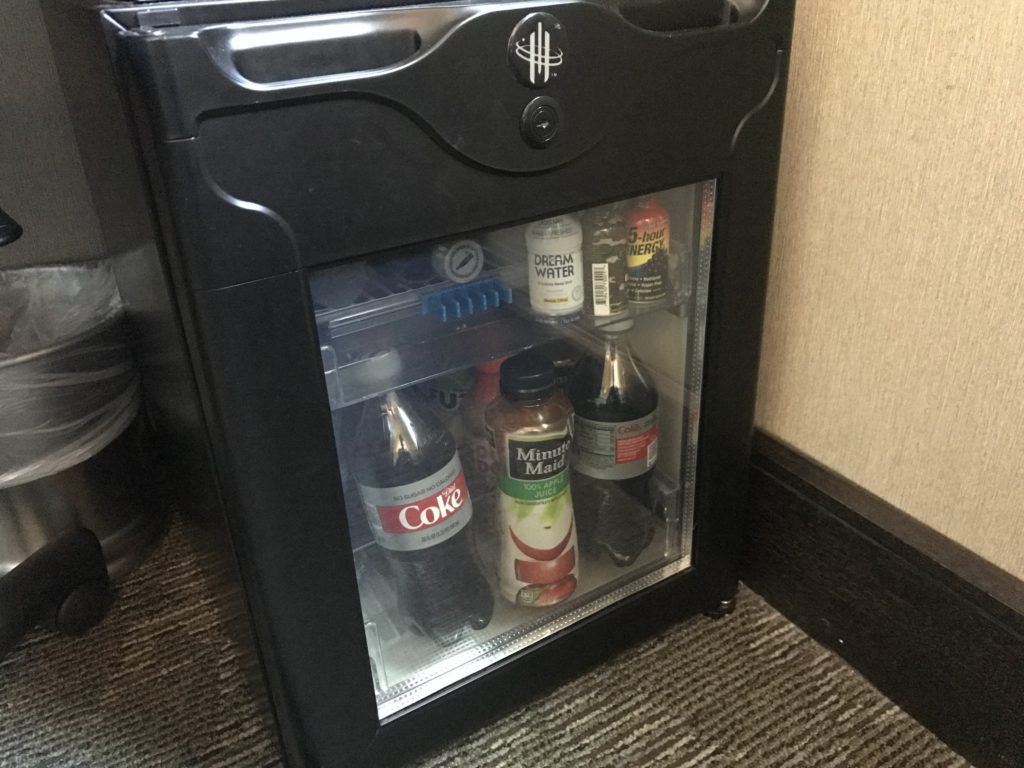 a small refrigerator with drinks inside