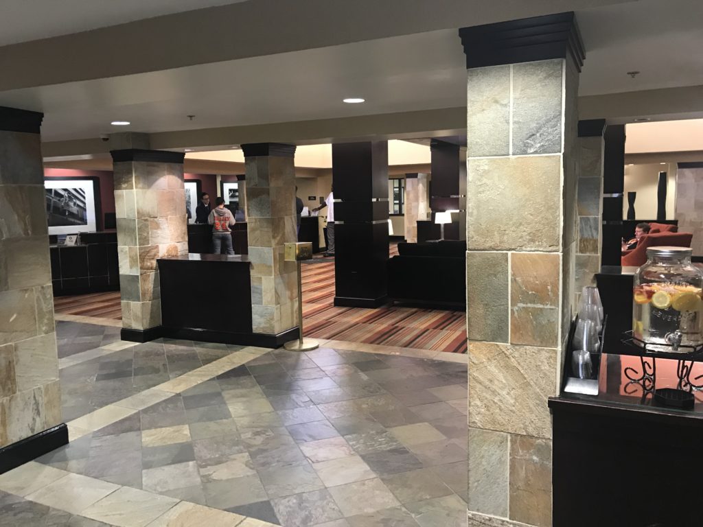 a lobby with stone pillars and a counter