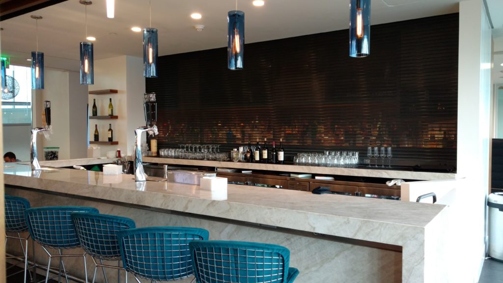 a bar with blue chairs and a counter