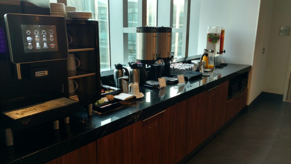 a counter with coffee machines and cups