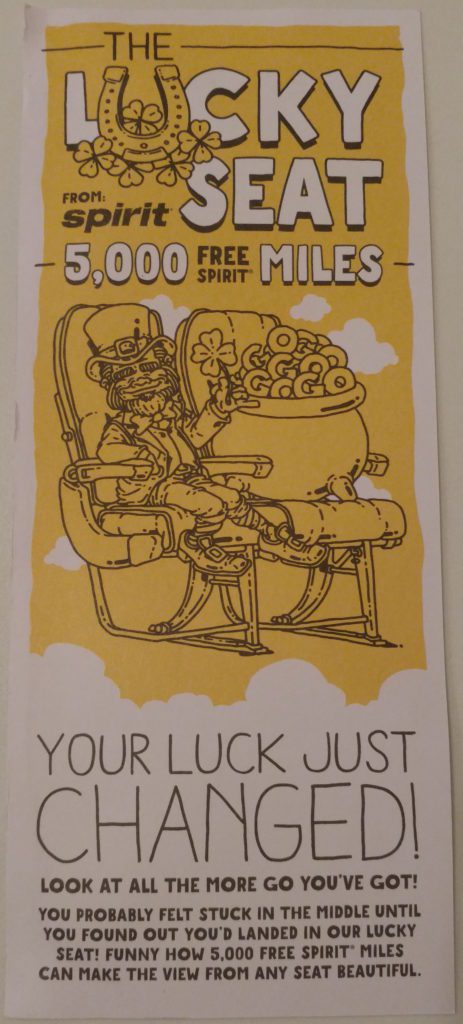 a yellow and white card with a leprechaun sitting in a chair