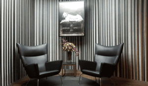 a room with chairs and a picture on the wall