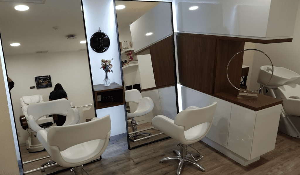 a hair salon with a mirror and chairs
