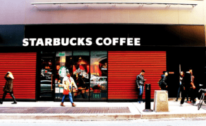 a group of people walking on the sidewalk