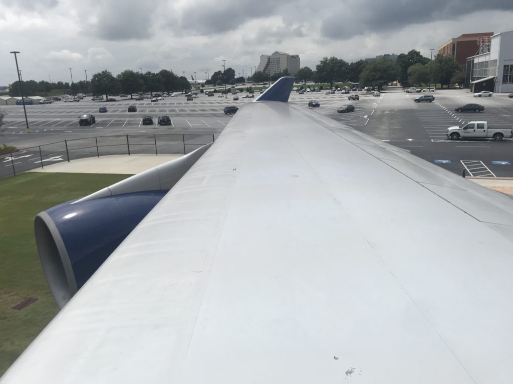 an airplane wing in a parking lot