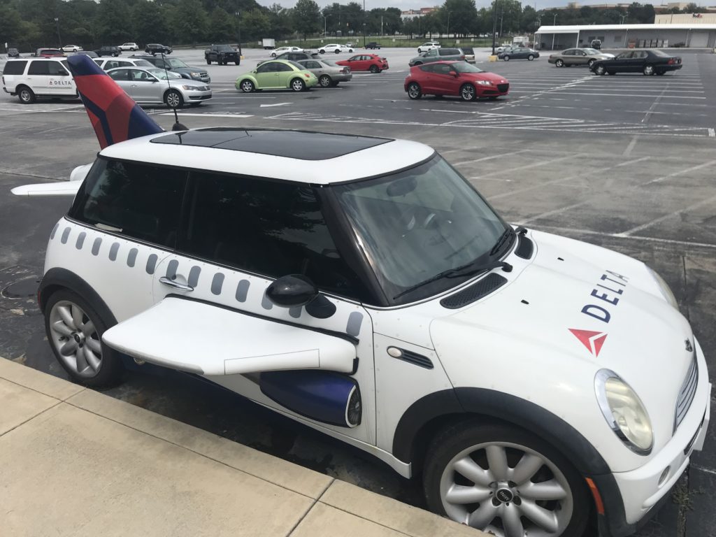 a white car with a plane wing on the side